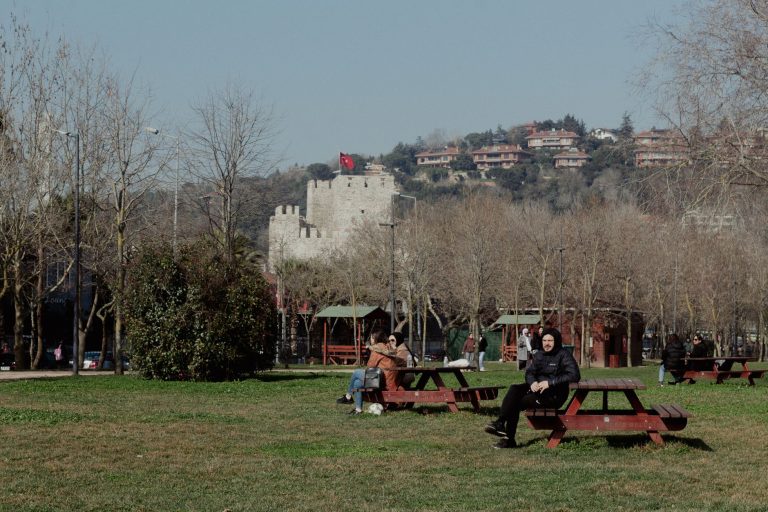 İstanbul'da Rumeli Hisarı yakınlarındaki bir parkta güneşli bir günün tadını çıkaran insanlar.